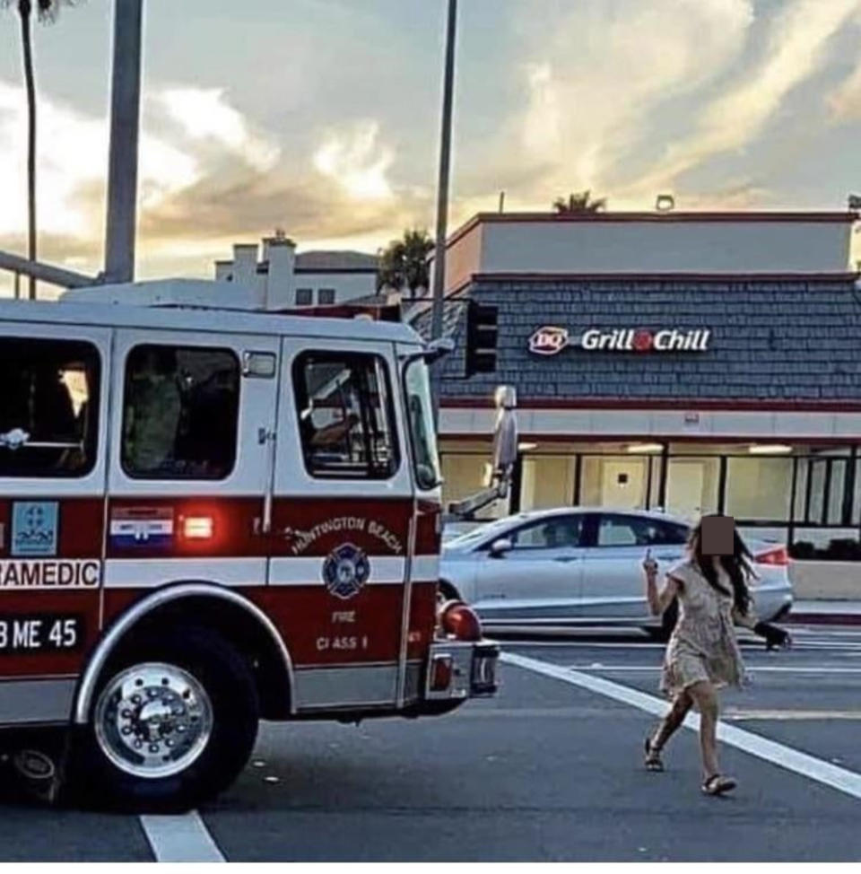 A woman giving a firetruck the finger