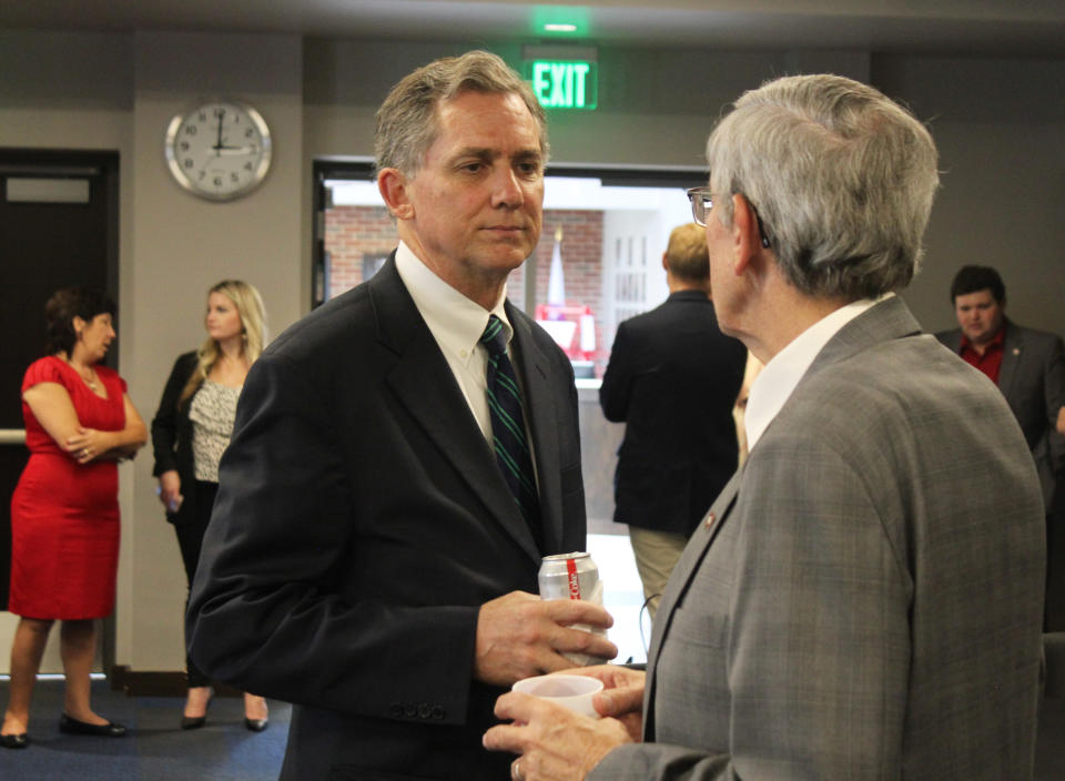 In this Aug. 27, 2018, photo, U.S. Rep. French Hill talks to state Rep. Jack Ladyman at the Republican Party of Arkansas headquarters in Little Rock, Ark. Hill, a Republican, is being challenged in Arkansas' 2nd Congressional District by Democrat Clarke Tucker, a state representative. (AP Photo/Andrew DeMillo)