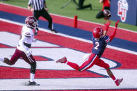 Liberty wide receiver Kevin Shaa (2) hauls in a touchdown pass in front of Massachusetts' Noah Boykin (4) during the first half of an NCAA college football game on Friday, Nov. 27, 2020, at Williams Stadium in Lynchburg, Va. (AP Photo/Shaban Athuman)