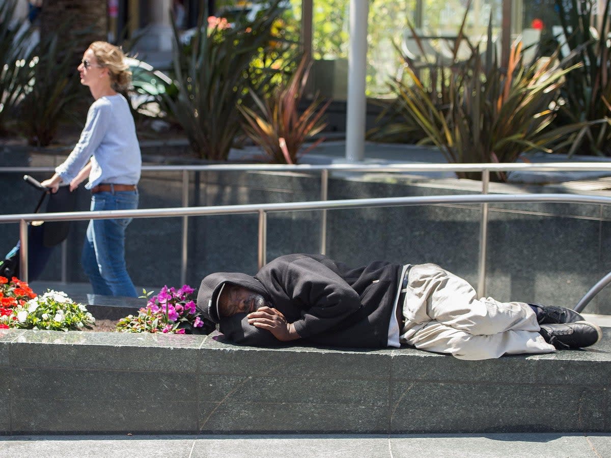 A homeless man sleeps in San Francisco, where more than 7,000 people have nowhere to live (AFP/Getty)