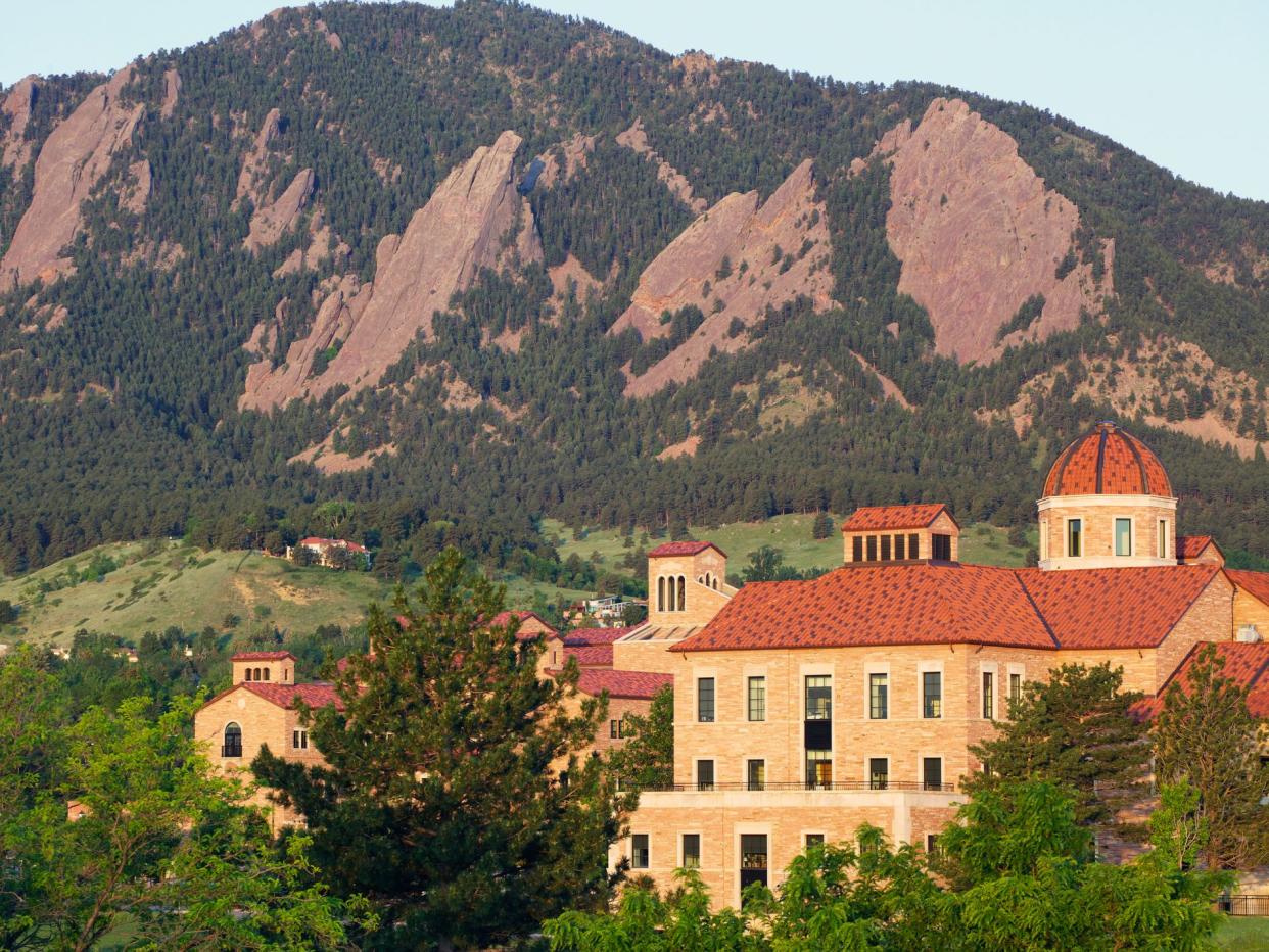 The flatirons behind a classroom building on the University of Colorado campus in Boulder Colorado.