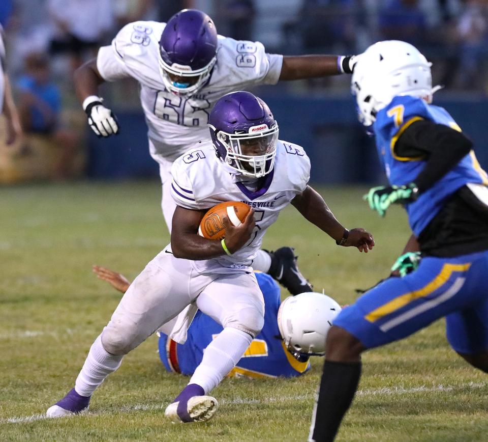 Gainesville High School quarterback Kyree Edwards (5) runs the ball through the Newberry High School defense, during a spring football game at NHS in Newberry FL. May 20, 2022. [Brad McClenny/The Gainesville Sun] 