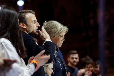 French President-elect Emmanuel Macron and his wife Brigitte Trogneux celebrate on the stage at his victory rally near the Louvre museum after results in the 2017 presidential election in Paris, France May 7, 2017. REUTERS/Philippe Wojazer