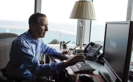 Thomas Herzfeld works in his apartment in Miami Beach, Florida December 23, 2014. REUTERS/Javier Galeano