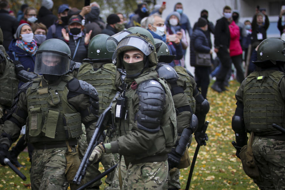 Armed police block demonstrators during an opposition rally to protest the official presidential election results in Minsk, Belarus, Sunday, Nov. 1, 2020. Some thousands of protesters swarmed the streets of the Belarus' capital on Sunday, demanding the resignation of the country's longtime authoritarian leader, and were met with police firing warning shots into the air and using stun grenades to break up the crowds. (AP Photo)