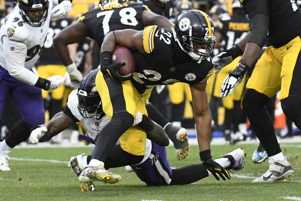 Pittsburgh Steelers running back Najee Harris slips the tackle by Baltimore Ravens linebacker Jason Pierre-Paul during the second half of an NFL football game in Pittsburgh, Sunday, Dec. 11, 2022. (AP Photo/Don Wright)