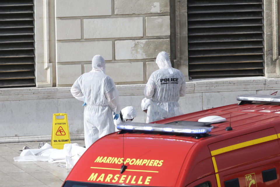 Investigative police officers work at a body outside Marseille ‘s main train station Sunday, Oct. 1, 2017 in Marseille, southern France. (AP Photo/Claude Paris)