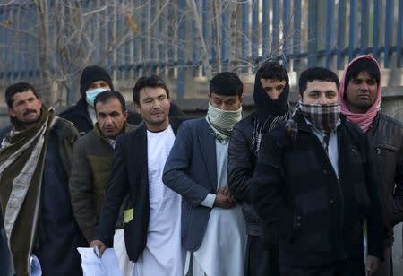 Afghan men queue up to apply for passports at a passport department office in Kabul, Afghanistan, November 29, 2015. REUTERS/Omar Sobhani