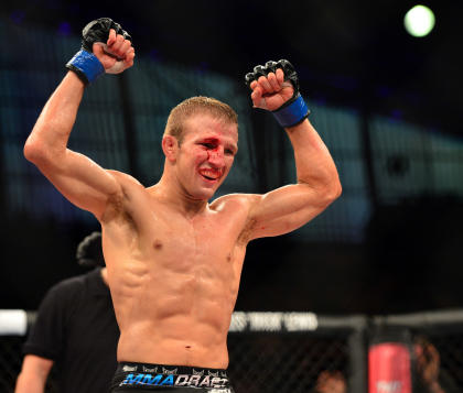 TJ Dillashaw will keep coach Duane Ludwig around a bit longer. (USA Today)