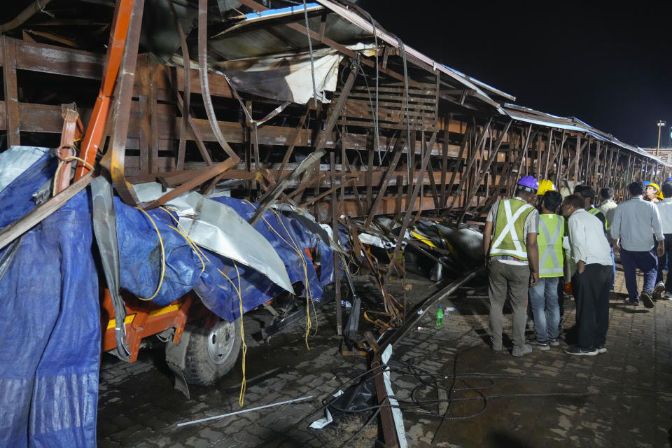 Rescuers look for victims under a billboard that collapsed following heavy rain and thundershowers in Mumbai, India, Monday, May 13, 2024. Scores of people were thought to be trapped after the collapse in the suburb of Ghatkopar, Mumbai police said on social media platform X. (AP Photo/Rafiq Maqbool)