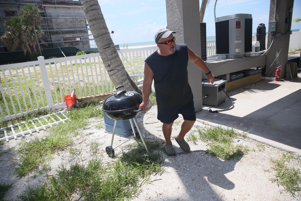 Paul ÒBruiserÓJungwirth, an employee of JPS Vacation Rentals secures items at a home on Fort Myers Beach, Florida on Monday, Aug. 28, 2023. Tropical Storm Idalia is approaching the state and is expected to be a hurricane by landfall. He said a lot of the homes that were represented by the company are now destroyed due to Hurricane Ian from last year. He says only a couple of homes are left.