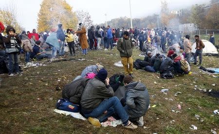 A group of migrants wait to enter a makeshift camp at the Austrian Slovenian border near the village of Sentilj, Slovenia, October 26, 2015. REUTERS/Leonhard Foeger REUTERS