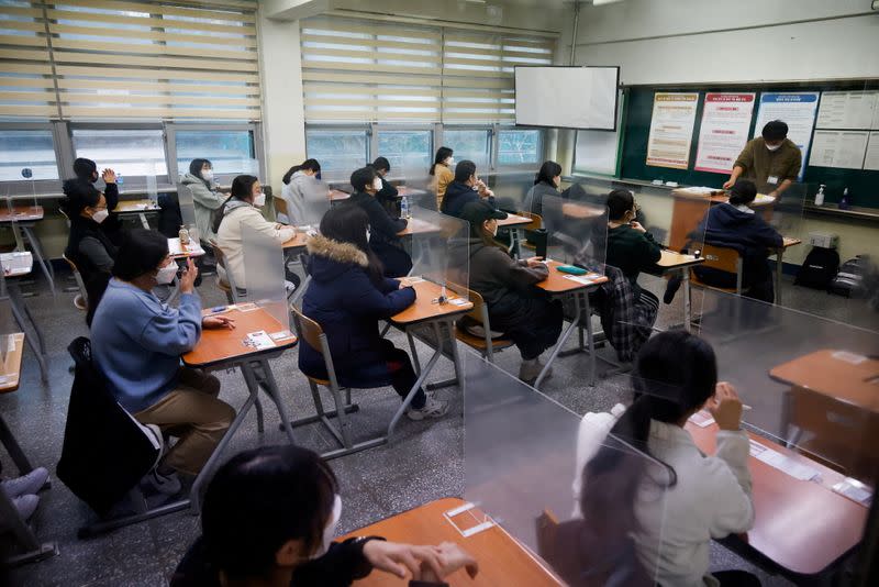 Students wait for the start of the annual college entrance examinations amid the coronavirus disease (COVID-19) pandemic at an exam hall in Seoul