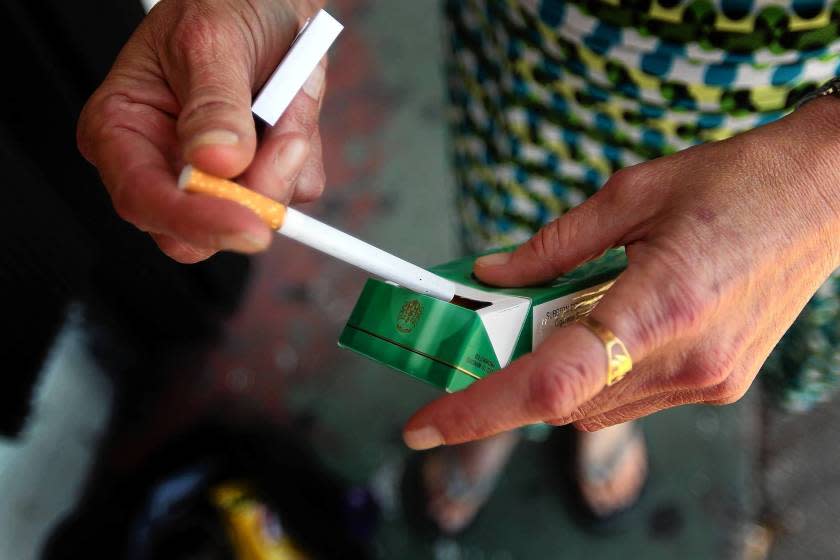 Menthol cigarettes pose a greater health risk to the public than unflavored tobacco, an FDA report says. The flavored cigarettes are more enticing, the agency suggests.