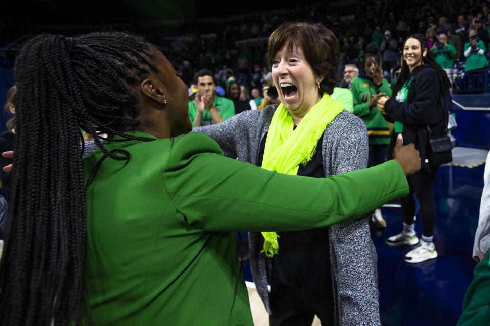 Former Notre Dame women's basketball head coach Muffet McGraw, right, celebrates with current women's basketball head coach Niele Ivey after an NCAA college basketball game against Connecticut on Sunday, Dec. 4, 2022, in South Bend, Ind. (AP Photo/Michael Caterina)