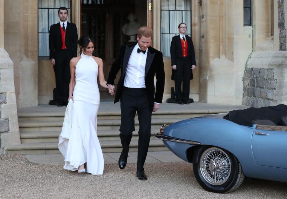 La duquesa de Sussex y el príncipe Harry, duque de Sussex salen del castillo de Windsor después de su boda para asistir a una recepción nocturna en Frogmore House, ofrecida por el príncipe de Gales el 19 de mayo de 2018 en Windsor, Inglaterra. 