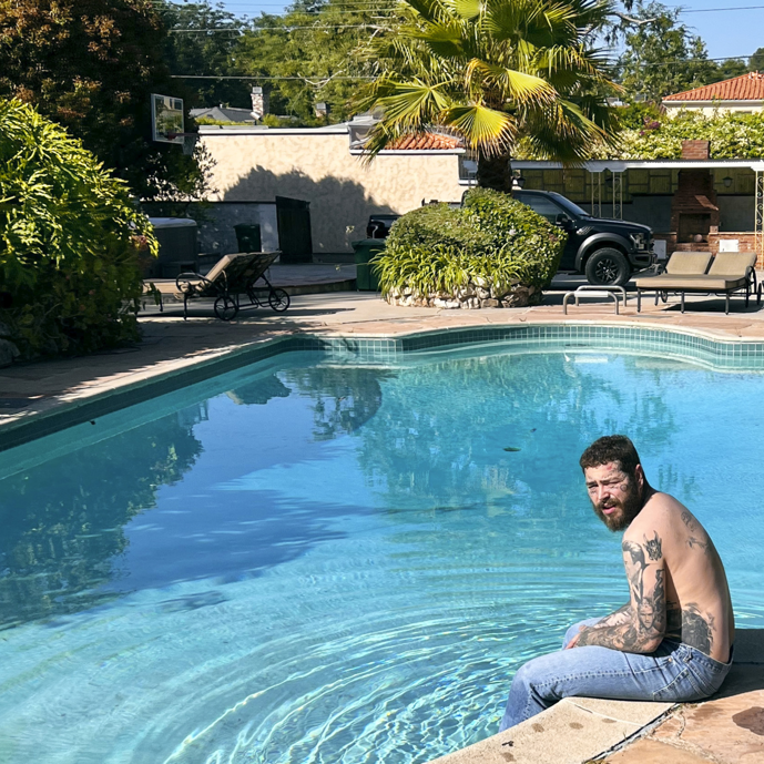 Post Malone seated by the pool in the cover of his most recent single, "Mourning," the first off his upcoming album, "Austin."