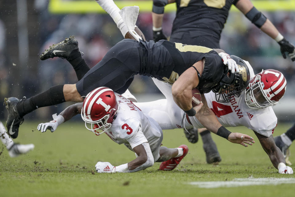 WEST LAFAYETTE, IN - NOVEMBER 30: Zander Horvath #40 of the Purdue Boilermakers is tackled by Tiawan Mullen #3 and Cam Jones #4 of the Indiana Hoosiers in the first half at Ross-Ade Stadium on November 30, 2019 in West Lafayette, Indiana. (Photo by Michael Hickey/Getty Images)