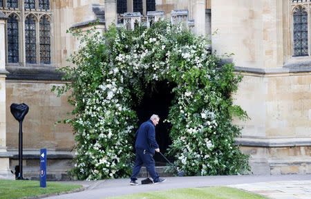 A man sweeps the path outside St George's Chapel in Windsor Castle ahead of the wedding of Prince Harry to Ms Meghan Markle in Windsor, Britain, May 19, 2018. Chris Jackson/Pool via REUTERS