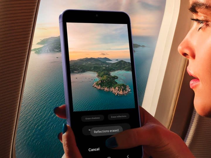 A woman takes a photo out the window of an airplane with the Samsung Galaxy S24.