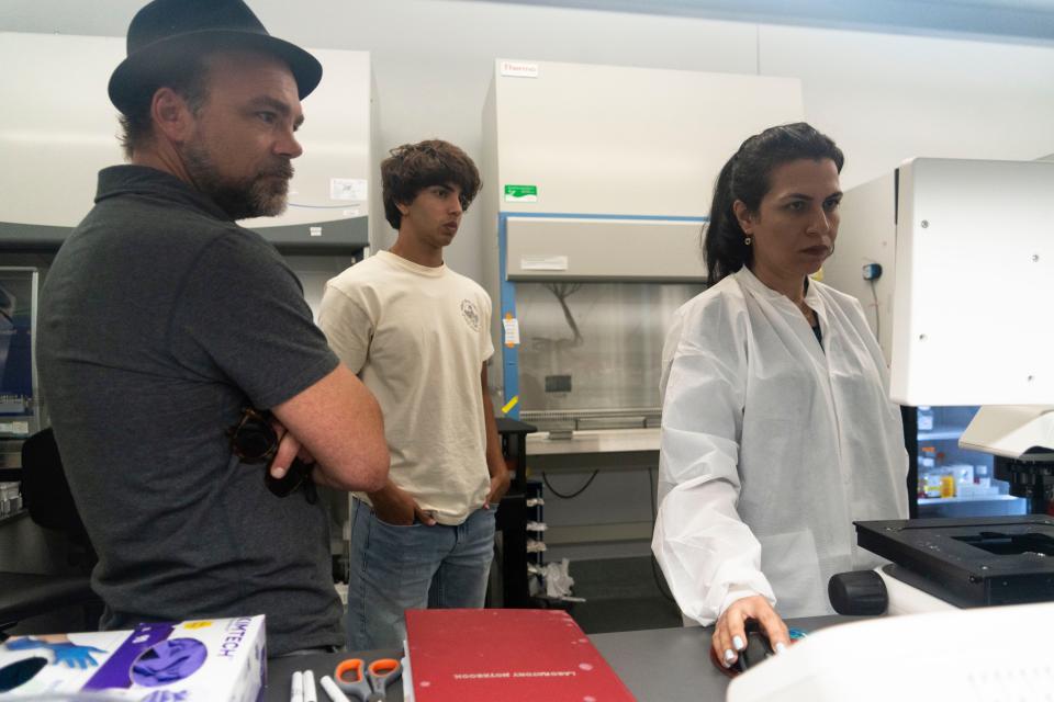 Casey McPherson, intern Samson Hinds and scientist Neda Ghosifam pull up pictures of samples at their ACC lab.