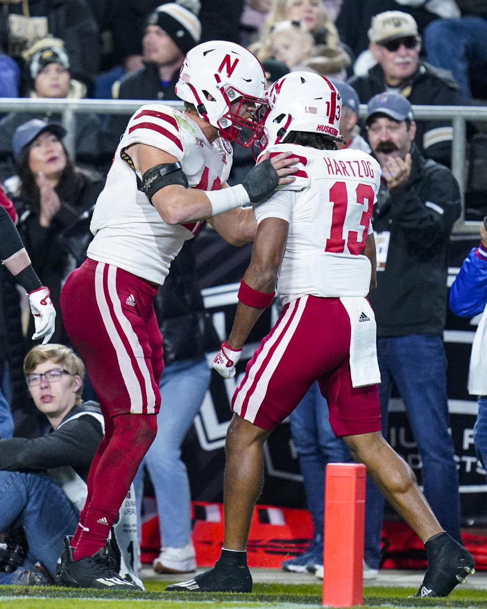 Nebraska defensive back Malcolm Hartzog (13) celebrates an interception with linebacker Nick Henrich (42) during the first half of an NCAA college football game against Purdue in West Lafayette, Ind., Saturday, Oct. 15, 2022. (AP Photo/Michael Conroy)