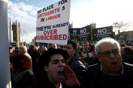 Protesters hold placards and flags during a demonstration, organised by the British Board of Jewish Deputies for those who oppose anti-Semitism, in Parliament Square in London, Britain, March 26, 2018. REUTERS/Henry Nicholls