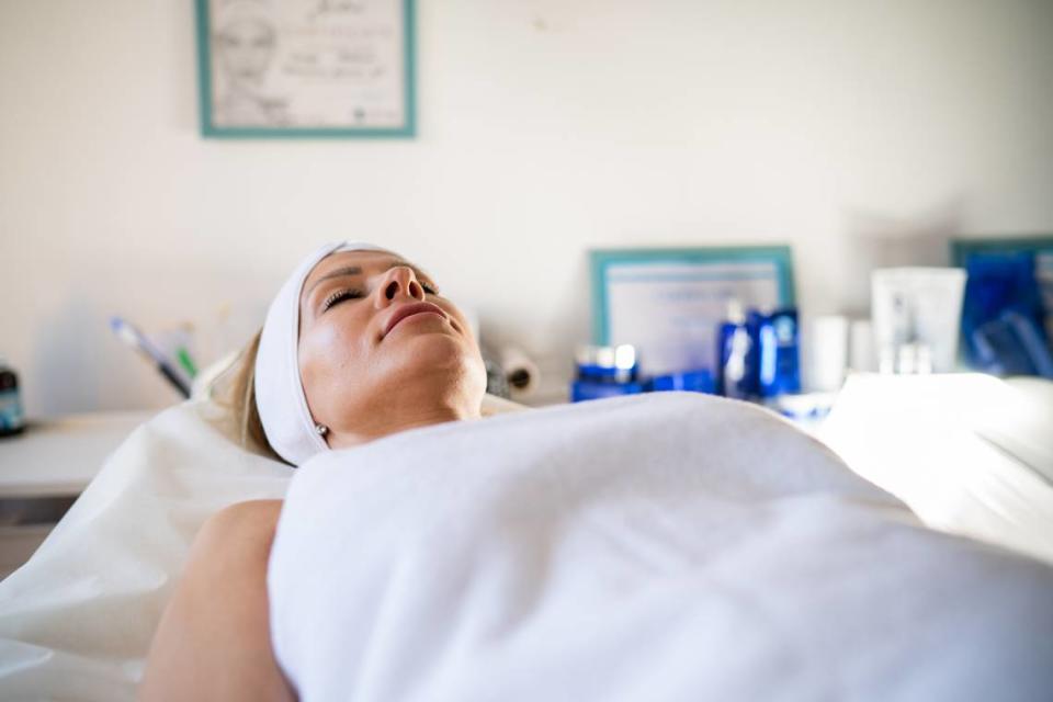 Woman is lying in bed in beauty salon and waiting for treatments