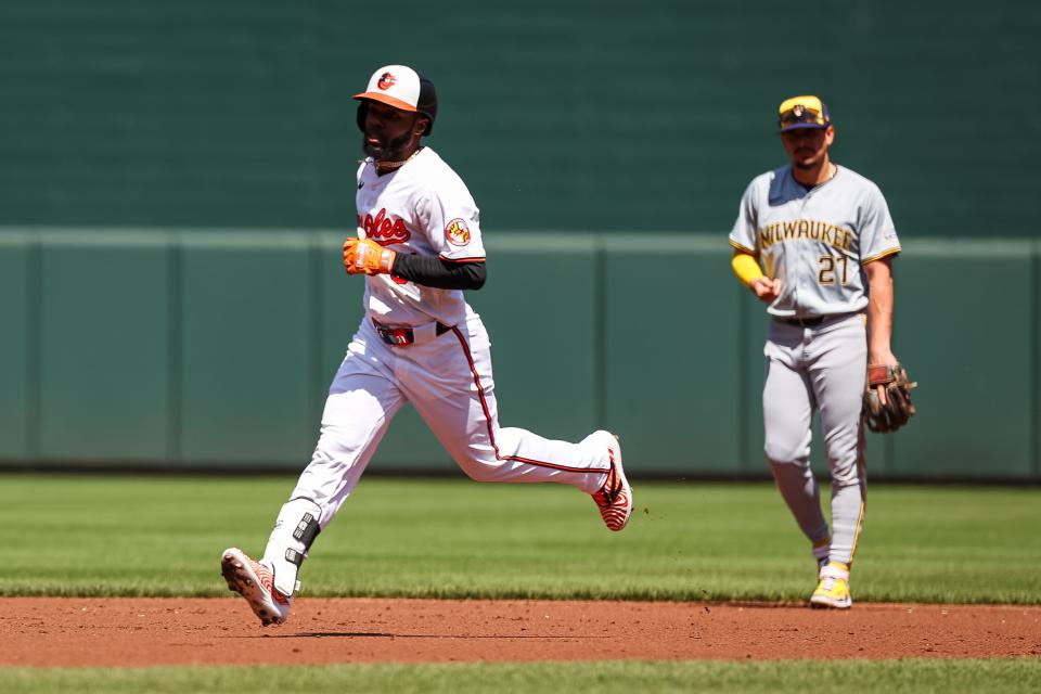BALTIMORE, MD - APRIL 14: Cedric Mullins #31 of the Baltimore Orioles rounds the bases in front of Willy Adames #27 of the Milwaukee Brewers after hitting a home run during the second inning at Oriole Park at Camden Yards on April 14, 2024 in Baltimore, Maryland. (Photo by Scott Taetsch/Getty Images)