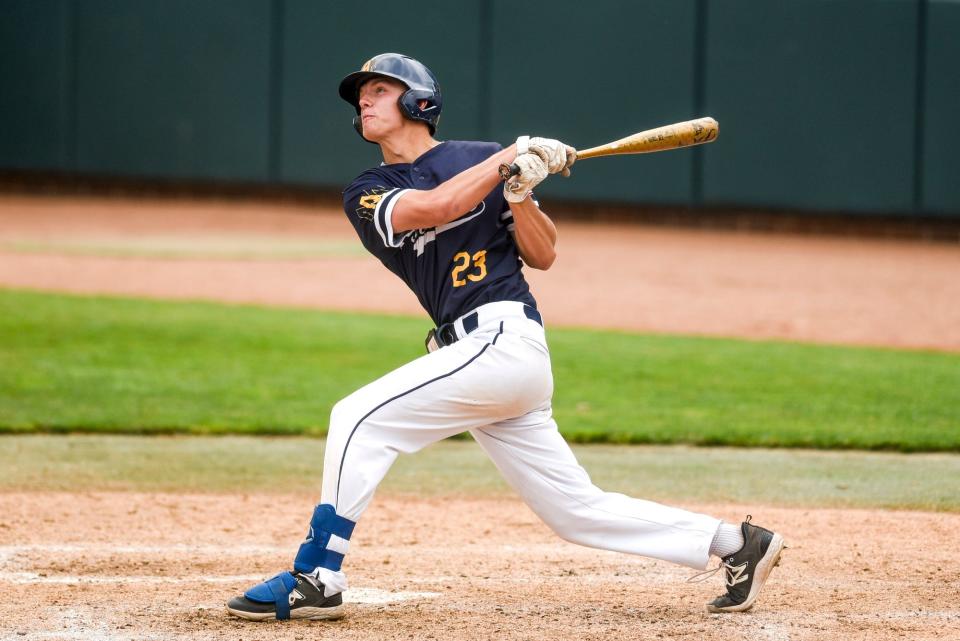 Algonac's Josh Kasner hits a 3-run home run against Lansing Catholic during the third inning on Thursday, June 15, 2023, at McLane Stadium on the MSU campus in East Lansing.