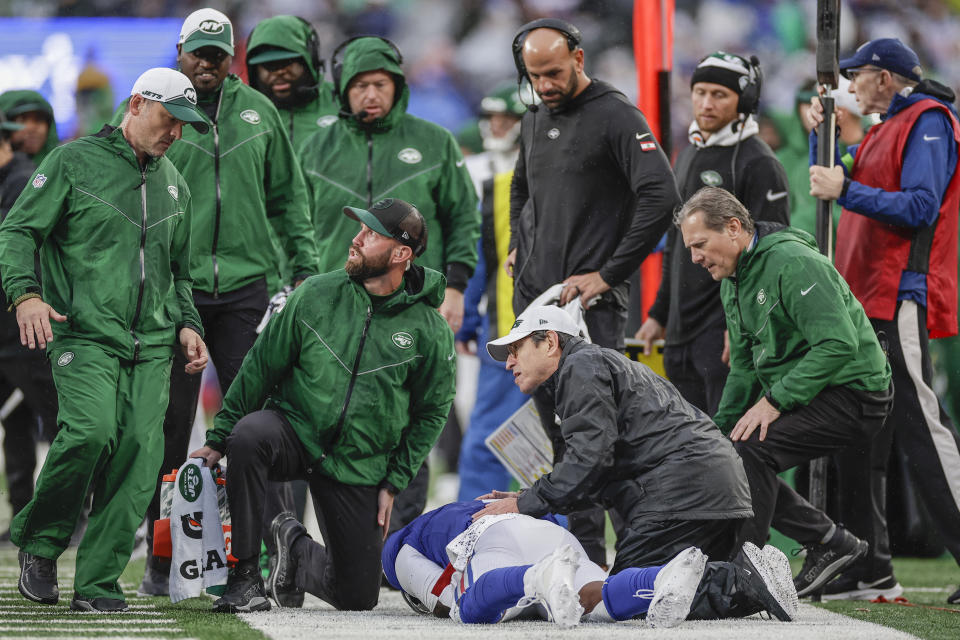 New York Giants quarterback Tyrod Taylor (2) lies on the New York Jets sideline after an apparent injury on a play during the first half of an NFL football game, Sunday, Oct. 29, 2023, in East Rutherford, N.J. (AP Photo/Adam Hunger)