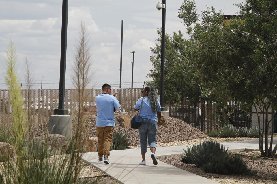Two Border Patrol sub-contractors, "monitors," brought for the first time to care for children walk outside at the Border Patrol station, Wednesday, June 26, 2019, in Clint, Texas. The decision to hire monitors for the facility followed revelations by lawyers who interviewed dozens of immigrant children who told them about Border Patrol agents who deputized older children to care for younger children. (AP Photo/Cedar Attanasio)