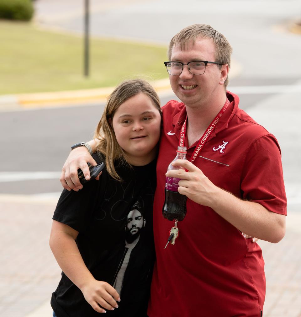May 5, 2022; Tuscaloosa, AL, USA; The Crossing Points Program at the University of Alabama rehearsed for the program's first ever graduation Thursday at Coleman Coliseum. Graduates Maeghan DeLoach and Colby Spangler hug each other as they arrive for practice. Mandatory Credit: Gary Cosby Jr.-The Tuscaloosa News