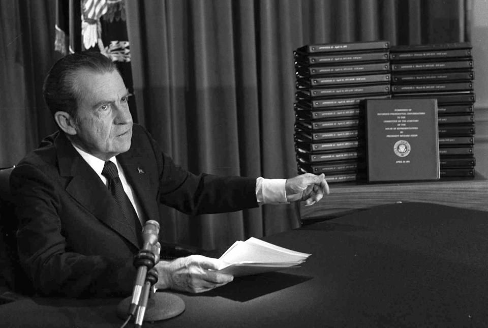 FILE - In this April 29, 1974, photo, President Richard Nixon points to the transcripts of the White House tapes after he announced during a nationally-televised speech that he would turn over the transcripts to House impeachment investigators, in Washington. (AP Photo/File)