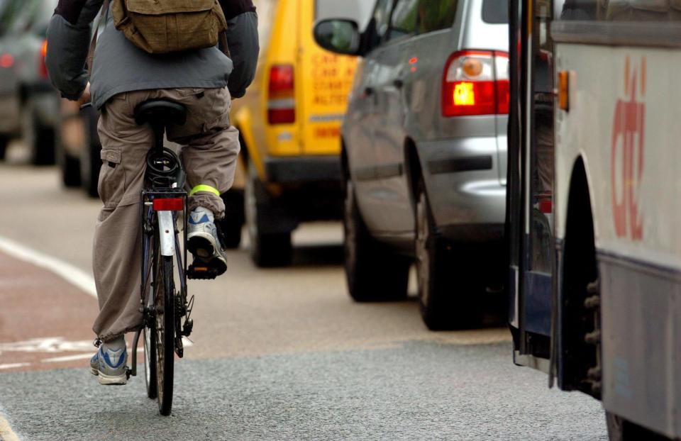 Spain is reportedly forging ahead with measures to keep cyclists safer (file picture of cyclist passing cars in the UK) (PA)