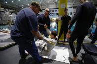 NASA Commercial Crew Astronaut Josh Cassada is helped to get into his space suit at NASA's Neutral Buoyancy Laboratory (NBL) training facility near the Johnson Space Center in Houston