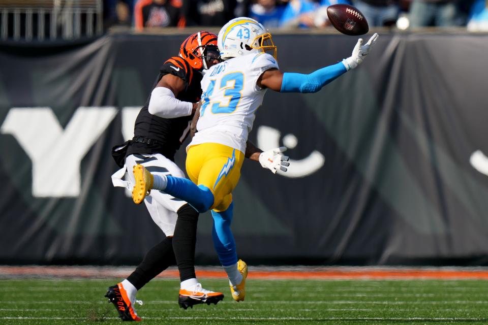 Los Angeles Chargers cornerback Michael Davis (43) intercepts a pass after Cincinnati Bengals wide receiver Ja'Marr Chase (1) caught and bobbled the pass in the first quarter during a Week 13 NFL football game, Sunday, Dec. 5, 2021, at Paul Brown Stadium in Cincinnati. 