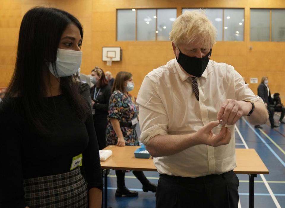 Prime Minister Boris Johnson shakes a dose of the pfizer vaccine (Matt Dunham/PA) (PA Wire)