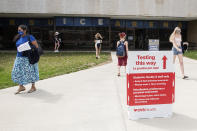 Students exit the KSU Ice Arena after getting their Johnson & Johnson COVID-19 vaccination at Kent State University in Kent, Ohio, Thursday, April 8, 2021. U.S. colleges hoping for a return to normalcy next fall are weighing how far they should go in urging students to get the COVID-19 vaccine, including whether they should — or legally can — require it. (AP Photo/Phil Long)