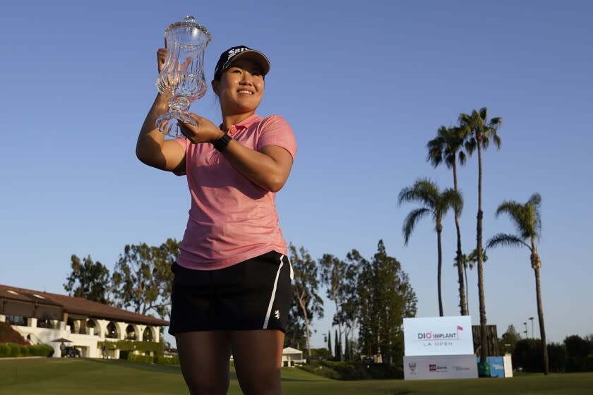 Nasa Hataoka holds the winner's trophy after winning the LPGA's DIO Implant LA Open golf tournament at Wilshire Country Club on Sunday, April 24, 2022, in Los Angeles. (AP Photo/Ashley Landis)