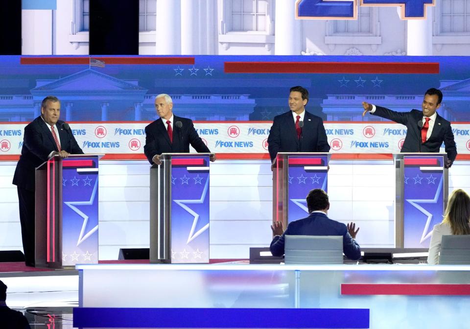 Republican presidential candidate Biotech entrepreneur Vivek Ramaswamy (far right- lives a thumbs down as other candidates speak at Fiserv Forum during the first 2023 Republican presidential debate in Milwaukee on Wednesday, Aug. 23, 2023