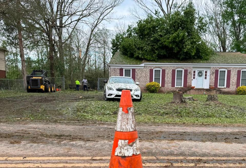 A tree is seen on the roof of a home in Rock Hill Monday morning. Several homes in the neighborhood have downed trees and power lines