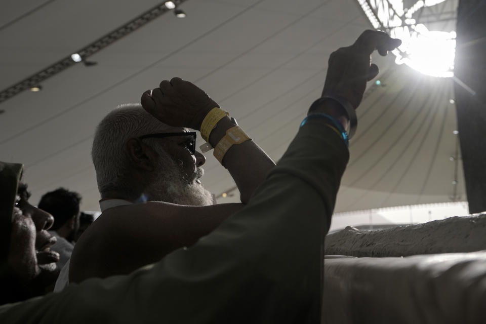 Pilgrims cast stones at a pillar in the symbolic stoning of the devil, the last rite of the annual Hajj pilgrimage, in Mina near the holly city of Mecca, Saudi Arabia, Wednesday, June 28, 2023. (AP Photo/Amr Nabil)