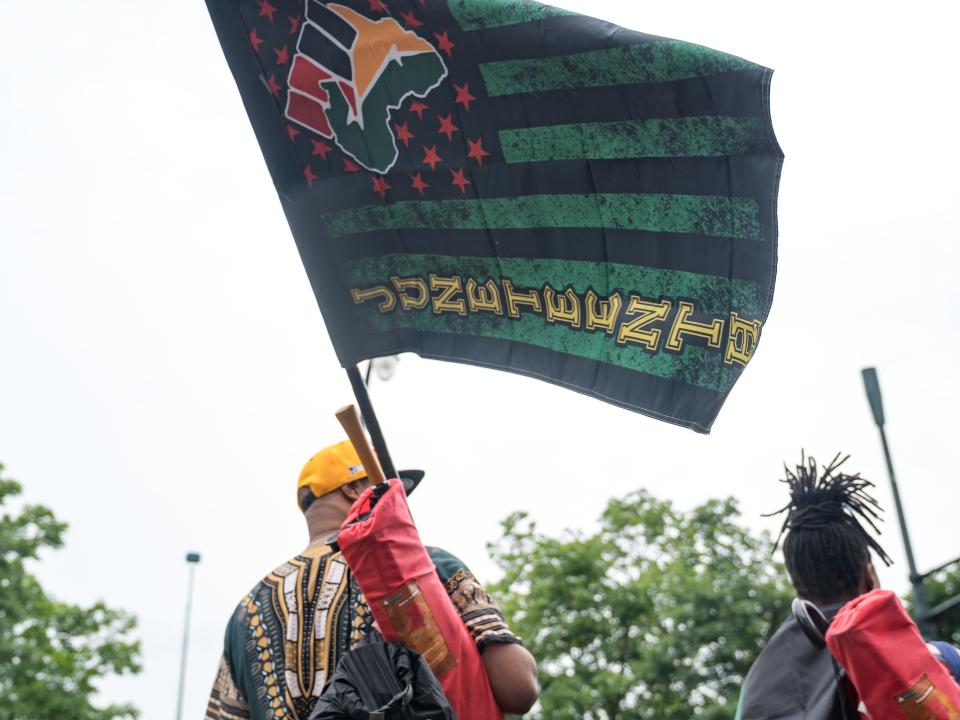 People watch a parade taking place to celebrate Juneteenth 2021 in Atlanta, Georgia.