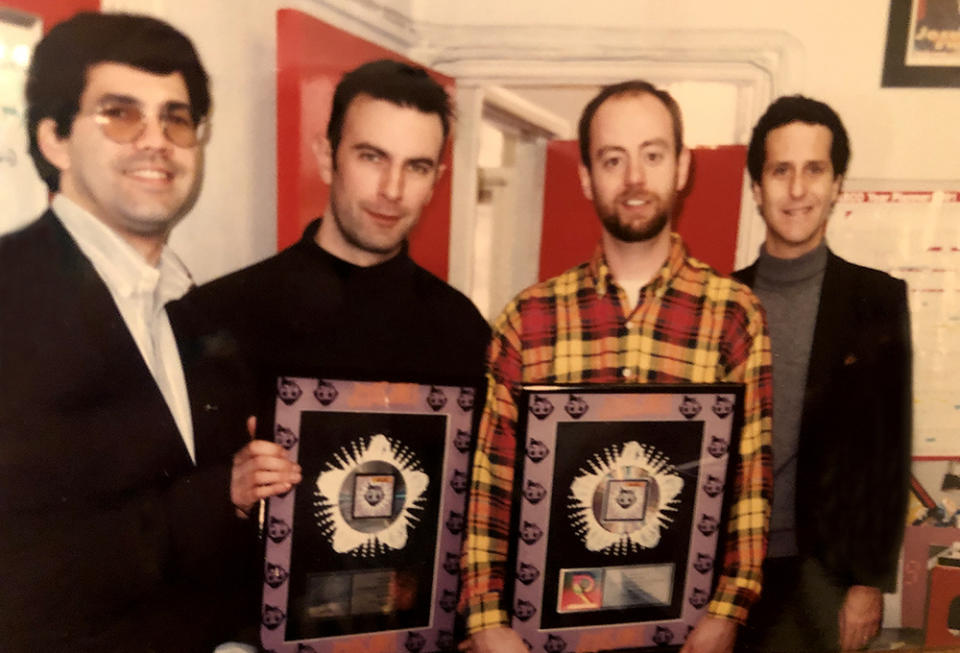 SBK A&R exec Mike Mena (left) and Daniel Glass (right) present Jesus Jones with RIAA plaques (Courtesy Daniel Glass) - Credit: Courtesy Daniel Glass