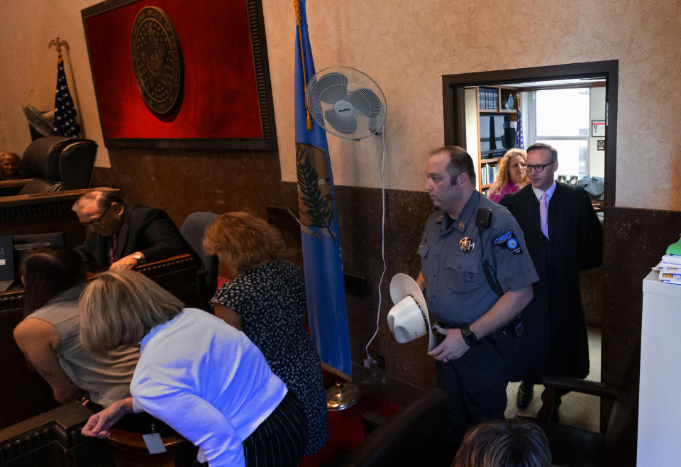 Judge Thad Balkman enters the courtroom before he delivers his decision in the opioid trial at the Cleveland County Courthouse in Norman, Okla., Monday, Aug. 26, 2019. Balkman ruled in favor of the state of Oklahoma and ordered Johnson and Johnson to pay $572 million to a plan to abate the opioid crisis. (Chris Landsberger/The Oklahoman via AP, Pool)