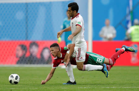 Soccer Football - World Cup - Group B - Morocco vs Iran - Saint Petersburg Stadium, Saint Petersburg, Russia - June 15, 2018 Iran's Vahid Amiri in action with Morocco's Amine Harit REUTERS/Henry Romero