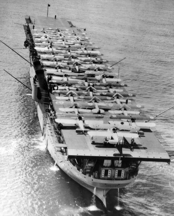 In Pearl Harbor, Oahu, Hawaiian Islands, with 34 planes on her flight deck, May 1928. Note booms rigged out from her sides. (NHHC)