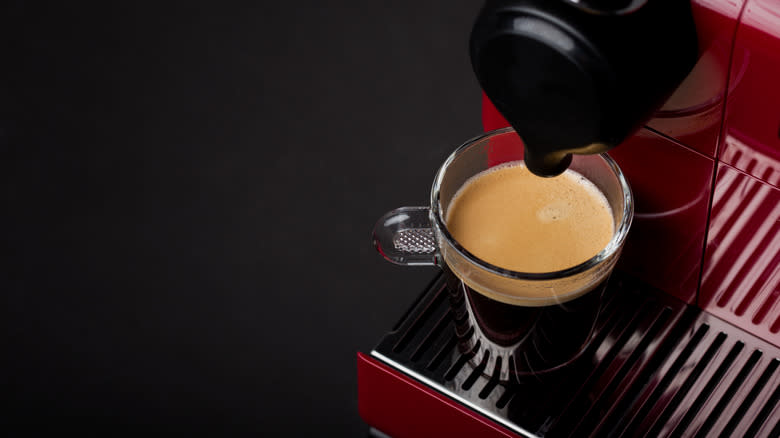 Nespresso machine making cup of coffee