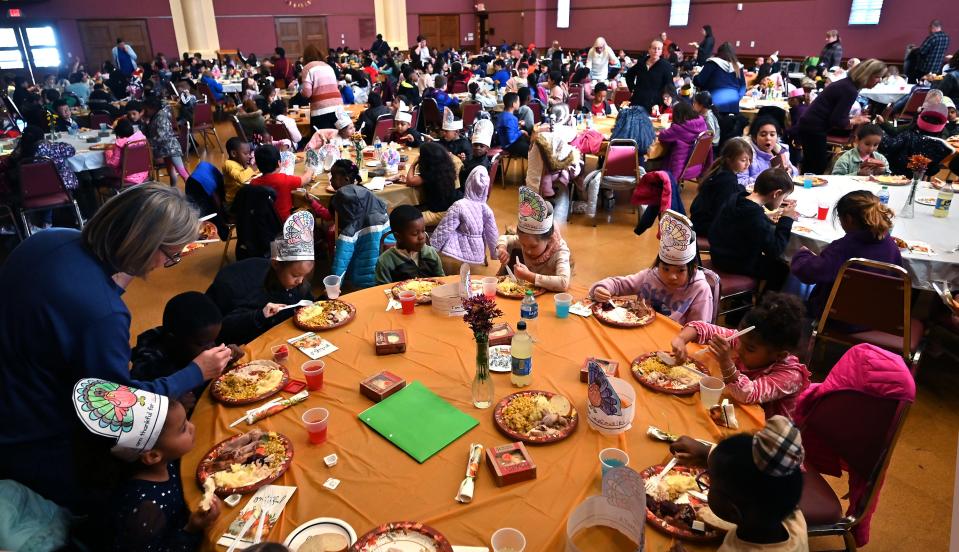Rice Square Elementary School students enjoy a Thanksgiving meal served by employees from area restaurants at Saint Spyridon Greek Cathedral.